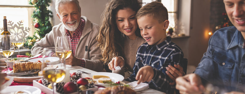 a happy family eating Christmas dinner