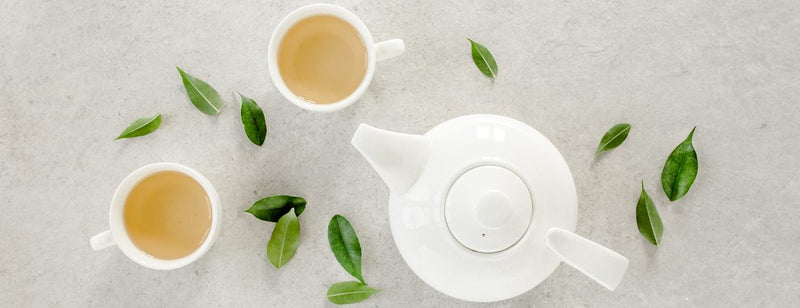 a pot of herbal tea with two mugs