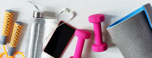 fitness mat, dumbbells, water bottle and skipping rope