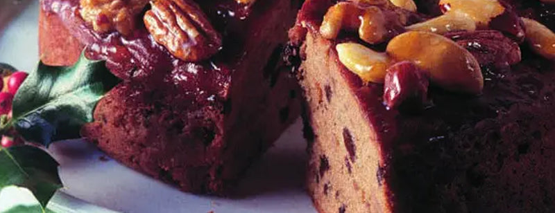 Freshly baked Christmas cake with holly decoration