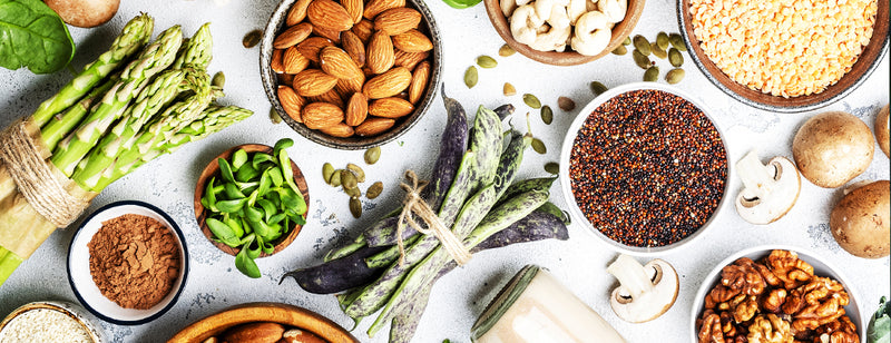 a selection of healthy plant based foods on a white table