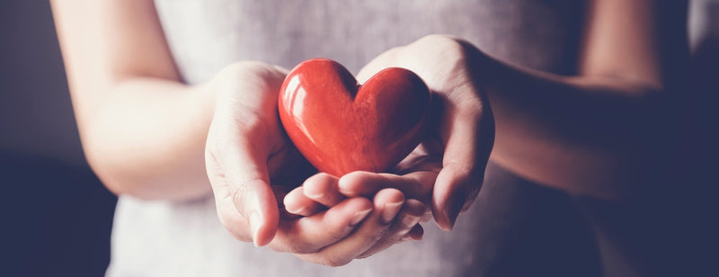 woman holding clay heart in her hands in honour of women's heart health