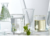 various oils in clear glass mixing bottles