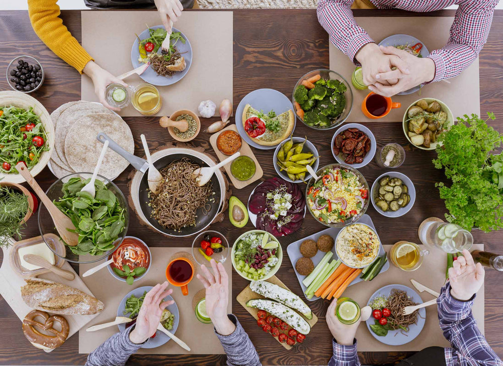 table laid with bowls and plates containing food