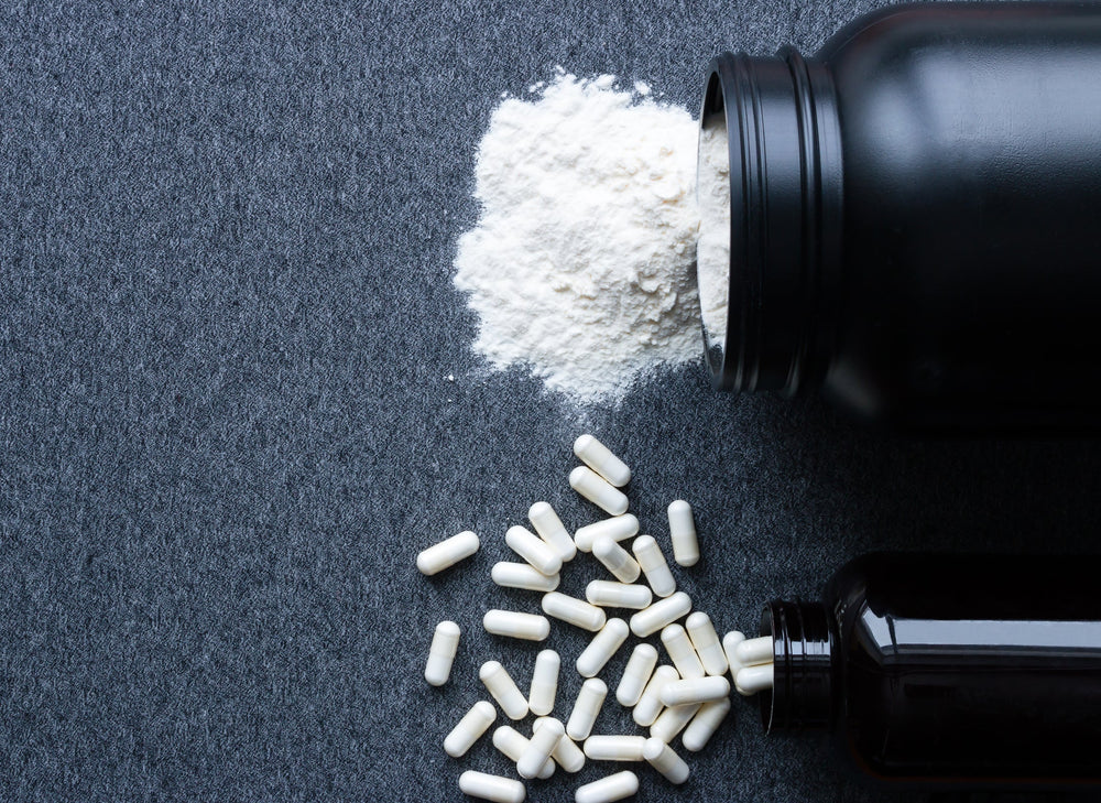 magnesium tablets and powder spilling from black bottles