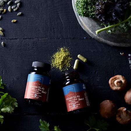 Terranova Vitamins with powder and capsule on dark background with greens