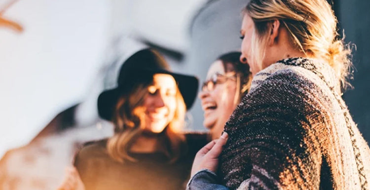group of women laughing and smiling