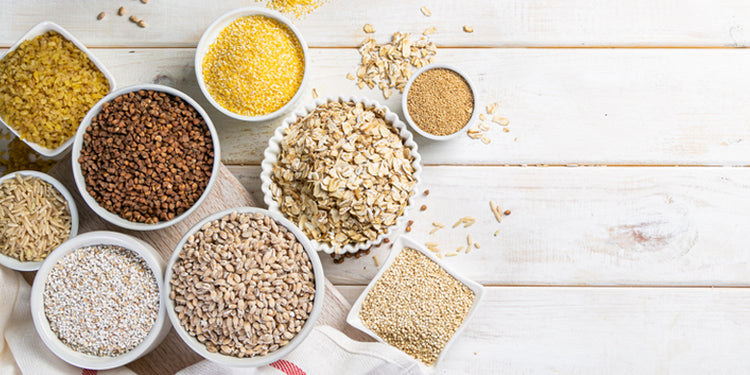 Selection of breakfast cereals in bowls on wooden table