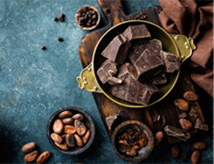 Chocolate in bowls with raw cacao beans