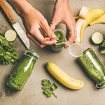 Hands stirring green juice