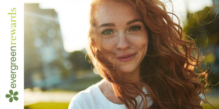 Evergreen Rewards logo with smiling girl with red hair