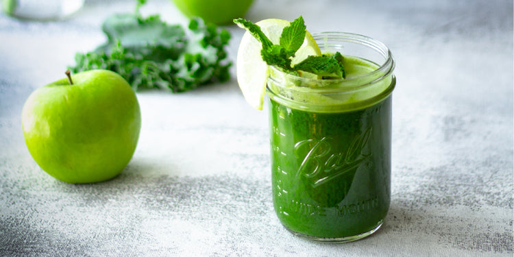Greens juice in Mason Jar with green apple and kale