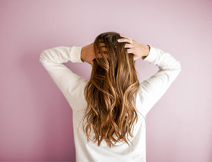 Woman running hands through long healthy hair