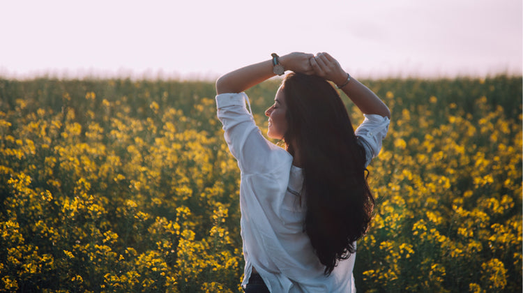 happy woman walking in a floral field