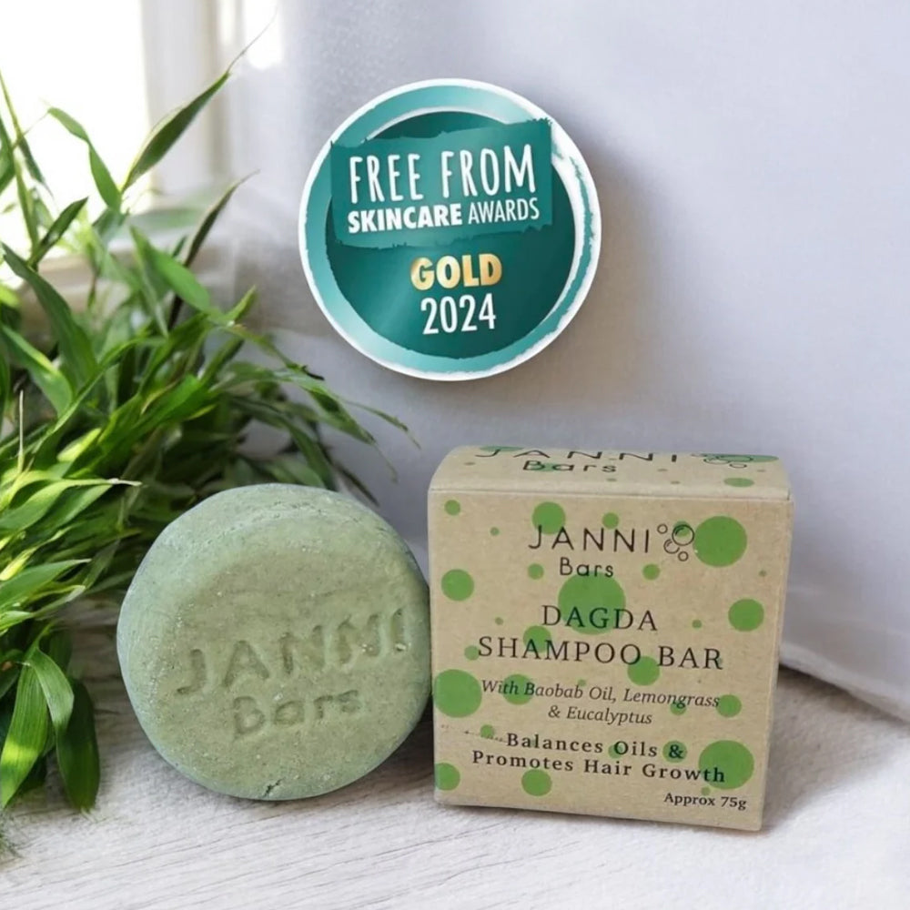 Janni Bars shampoo bar and packaging with a plant and award badge in the background
