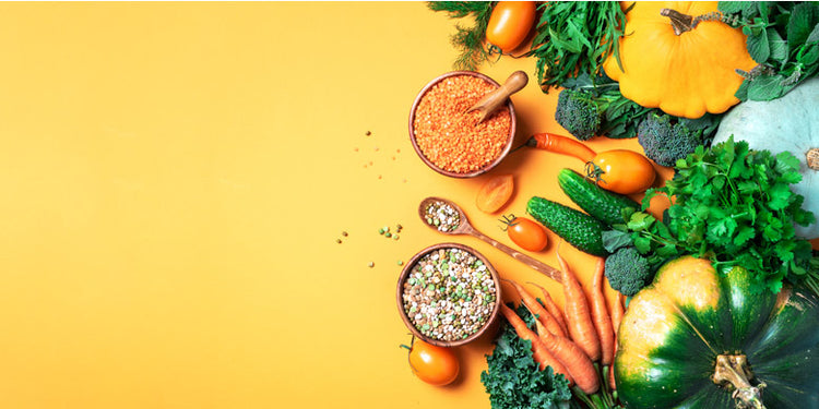 range of colourful organic food on yellow background