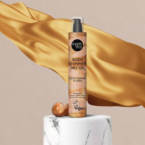 Organic Shop Gold Jojoba & Shea Body Shimmer Oil with silk background