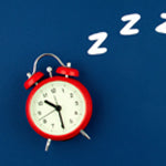 red alarm clock on a navy background