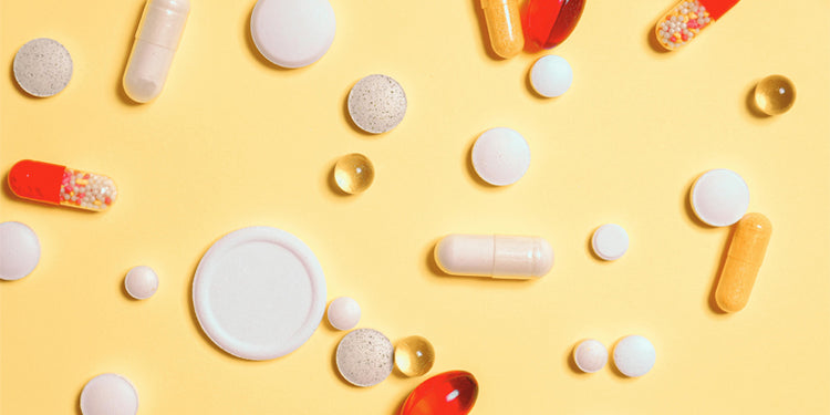 range of tablets and capsules on a yellow background