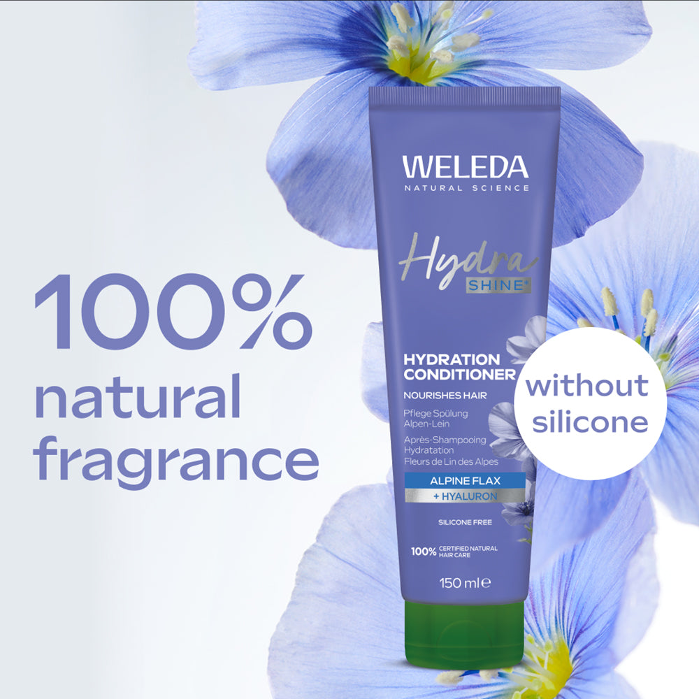 Weleda Hydra Shine conditioner tube with blue flowers in the background