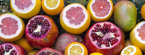 cirtus fruits cut open including grapefruit, oranges, lemons and mangos