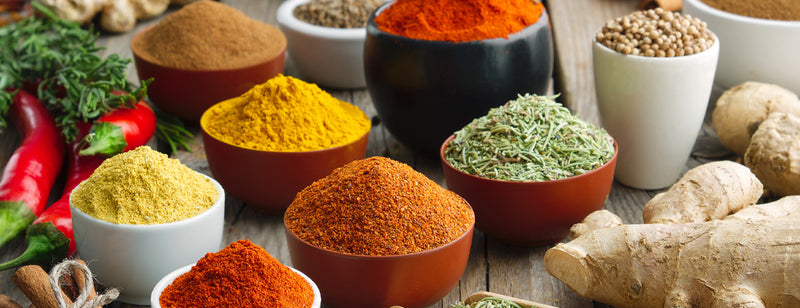 selection of herbs and spices in wooden bowls