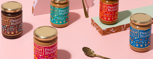 nutshed nut butters on pink background with spoon 