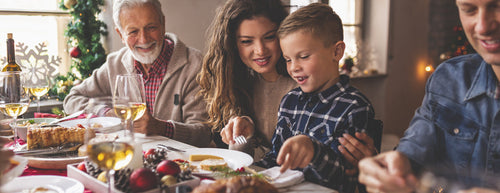 a happy family eating Christmas dinner 