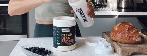 nuzest clean lean protein with shaker in kitchen