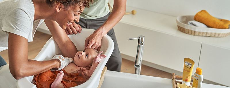 Mother with happy baby in the bath 