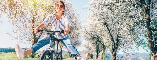 woman cycling in the countryside - one of the best exercises for heart health