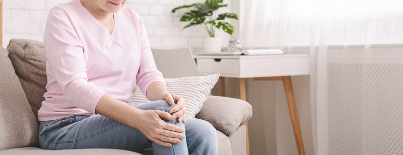 woman sitting on the couch with sore joints