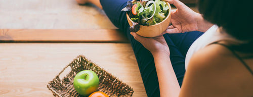 woman eating healthy salad following the DASH diet 