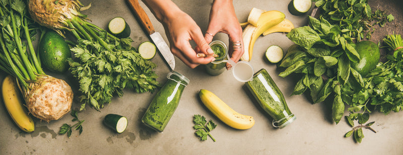 woman preparing a green smoothie to help detox the body naturally