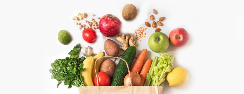 brown paper bag with healthy foods that are important for a healthy gut