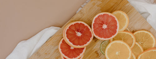 chopping board with slices of grapefruit and orange