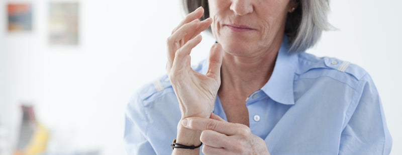 woman with osteoporosis checking her wrist