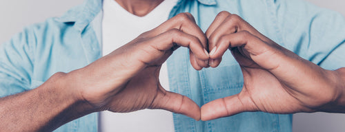 man making heart shape with his hands