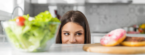 woman trying to fight sugar food cravings with a salad