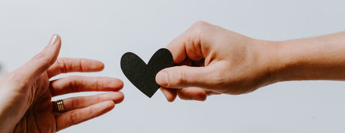 How To Support Your Heart Health - 2 hands with a paper heart