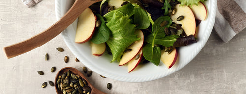 bowl of spinach and pumpkin seed salad, full of iron