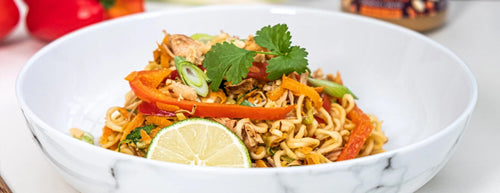 Jackfruit Pad Thai with peppers and fresh coriander, in a white bowl