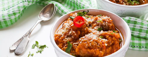 a bowl of lentil meatballs with fresh tomato sauce