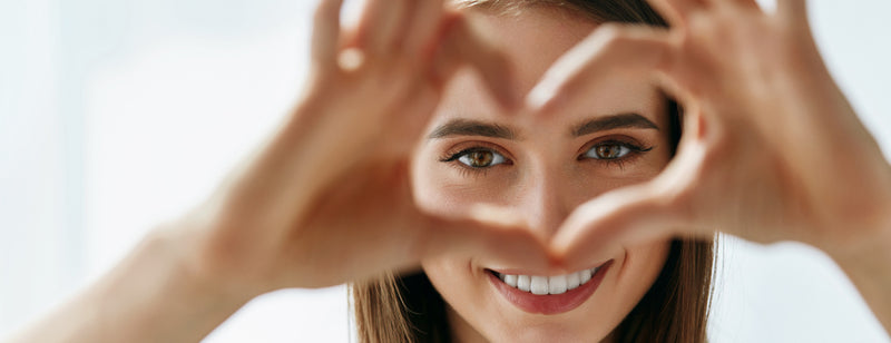 woman making heart shape in front of her eyes to emphasise the importance of eye health