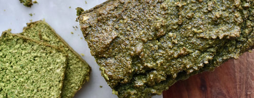 Freshly sliced Super Greens Bread on a wooden board