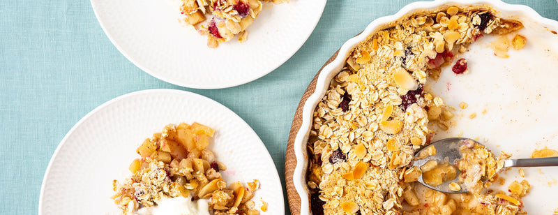 dish with oaty fruit crumble and two plates of pie