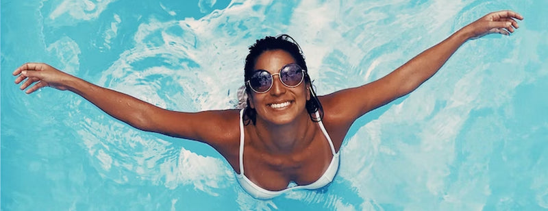 happy woman with great skin in a swimming pool in summer