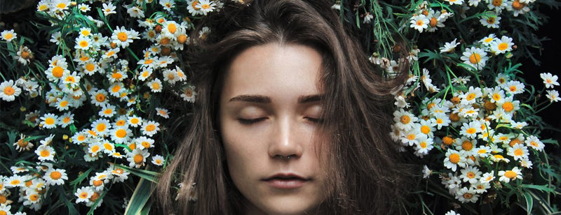 woman sleeping well in a bed of daisies