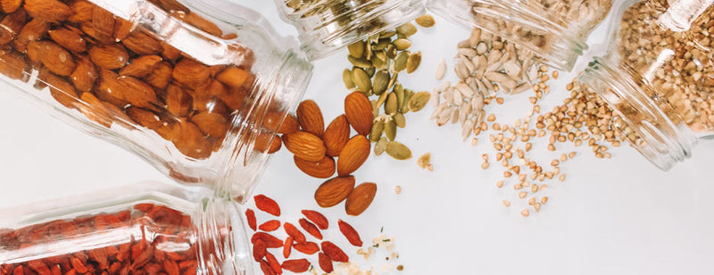 select of superfoods in jars on a white worktop