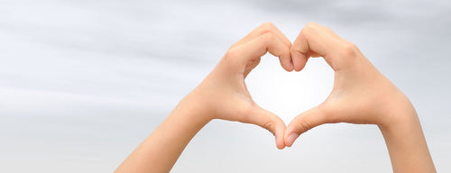 woman making heart shape with hands